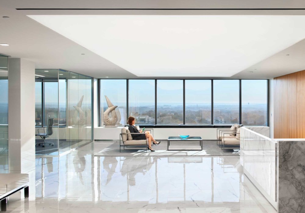 Flat panel lighting and square downlights in an office lobby