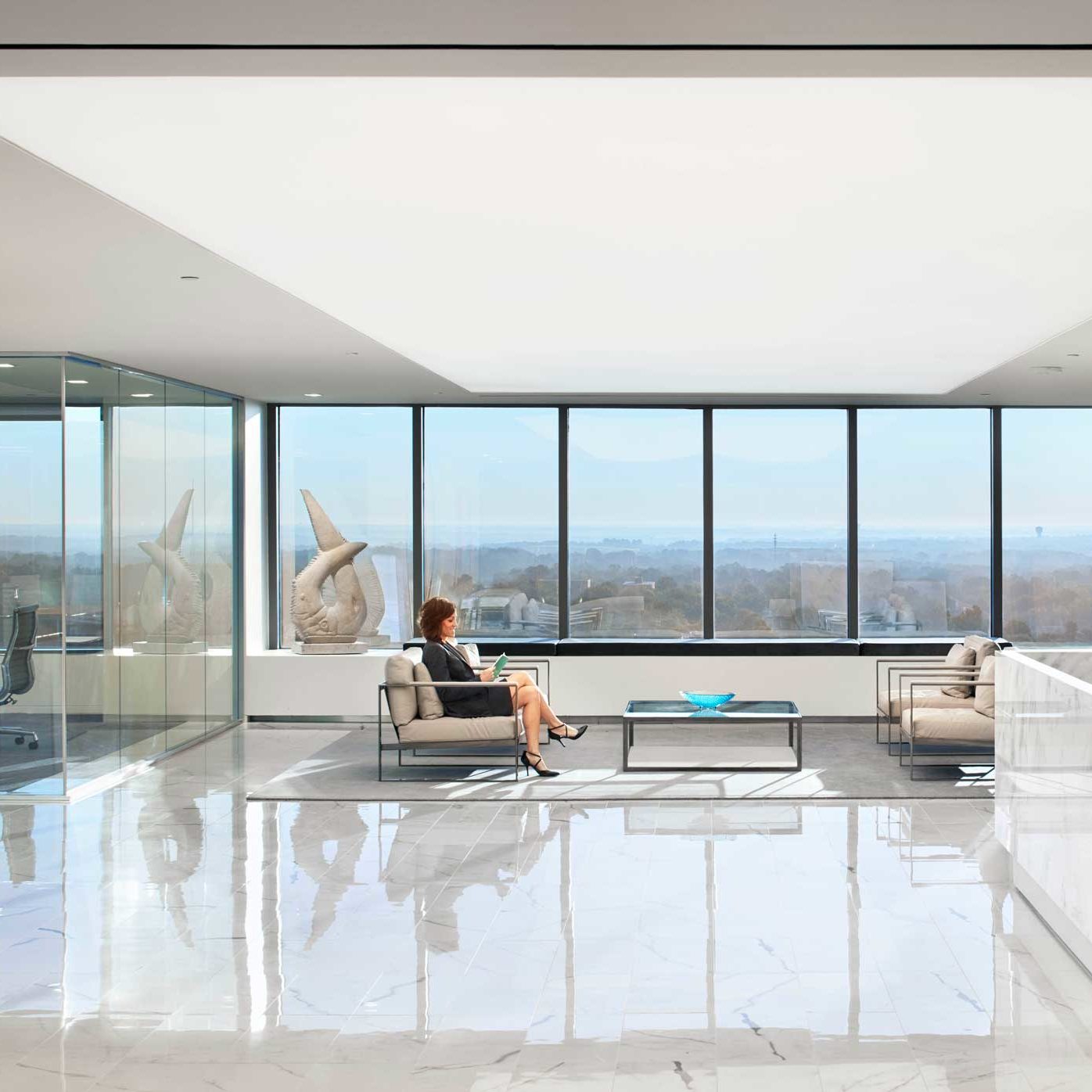 Flat panel lighting and square downlights in an office lobby