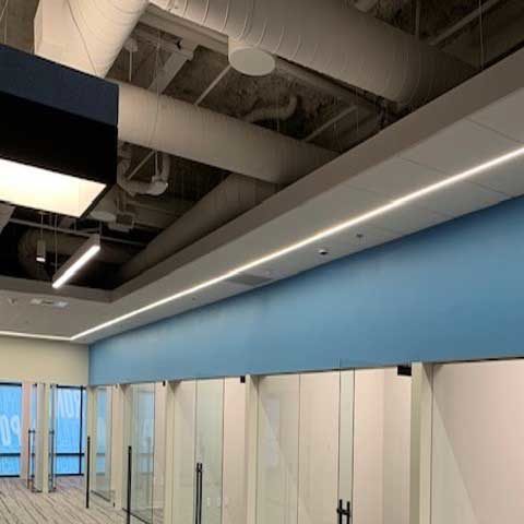 Recessed linear lighting in an office hallway