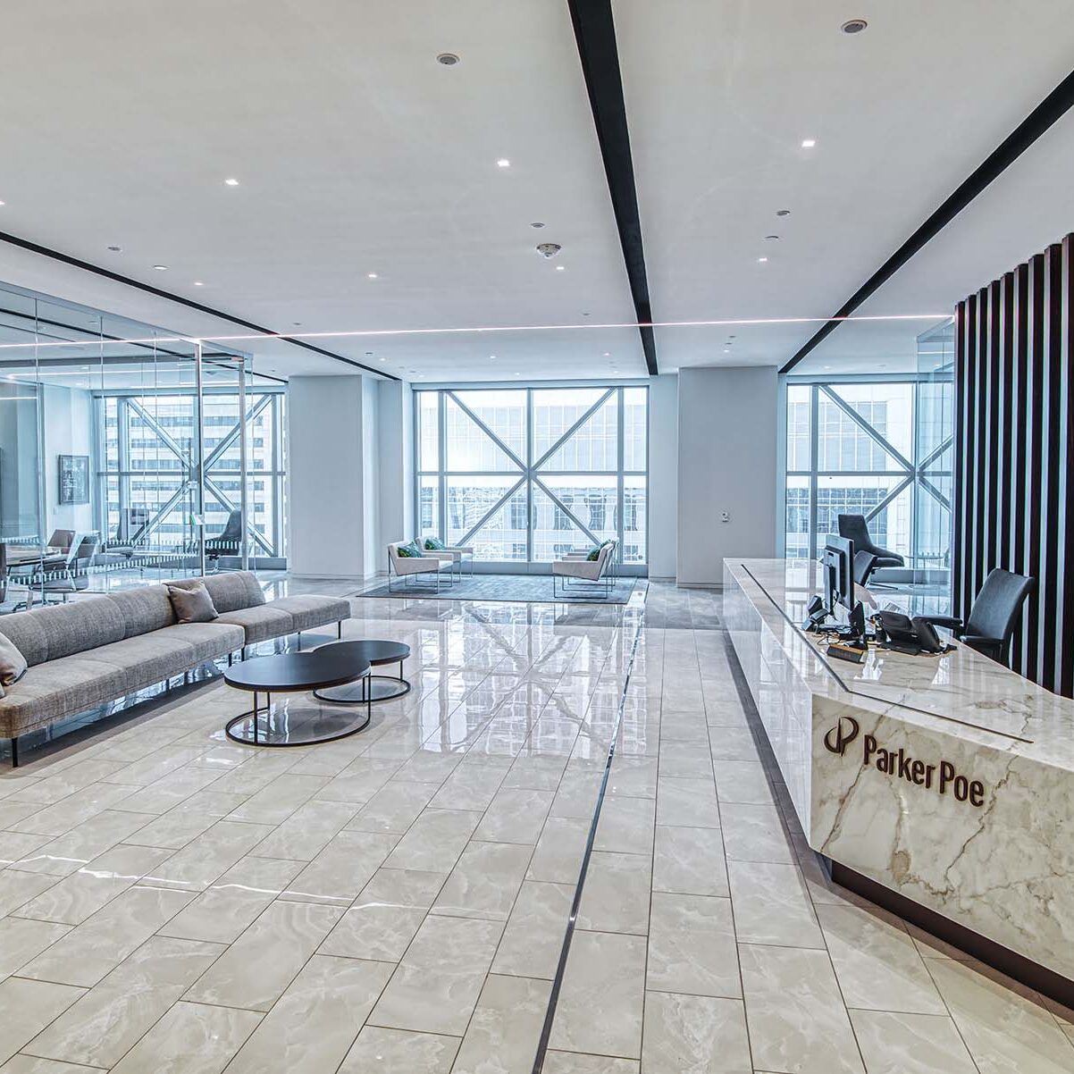 Linear lighting and recessed downlights in an office lobby