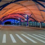 Colorful wash lighting inside an airport canopy