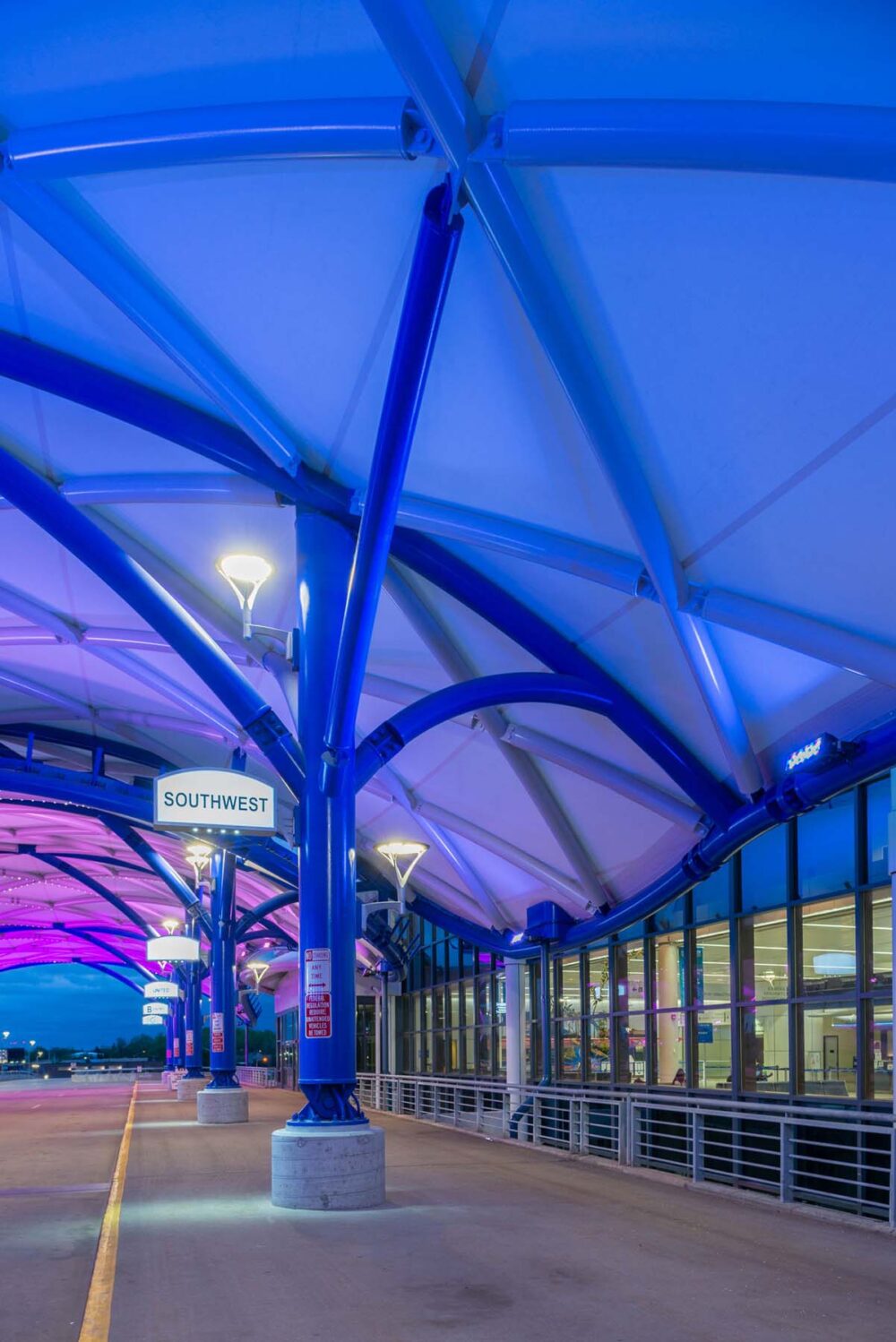 Colorful wash lighting inside an airport canopy