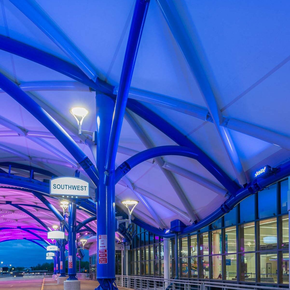 Colorful wash lighting inside an airport canopy