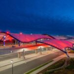 Colorful wash lighting outside an airport canopy